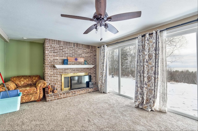 living room with carpet floors, a textured ceiling, and a brick fireplace