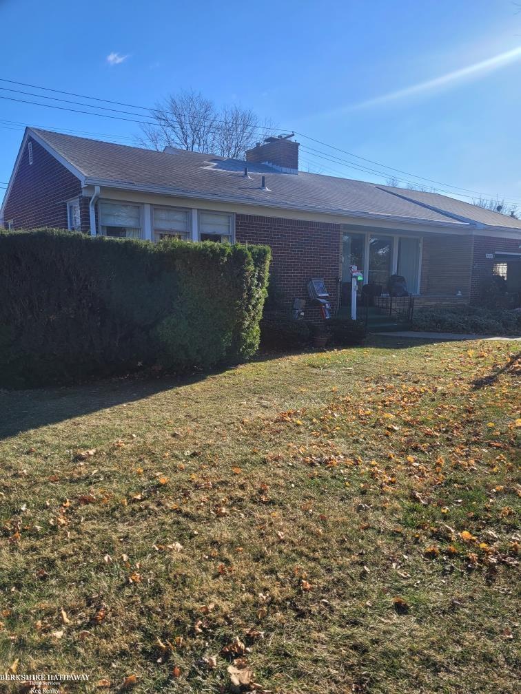 back of house featuring a yard and a patio area