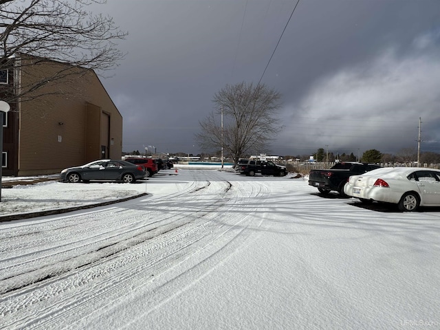 view of snow covered parking