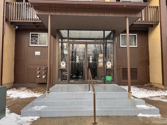 view of snow covered property entrance