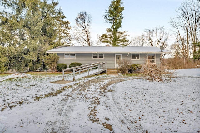 view of snow covered back of property