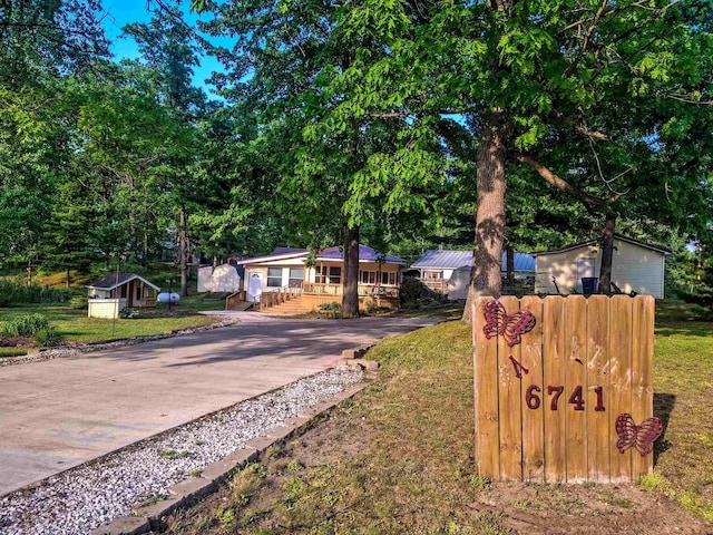 6741 Carpenter Rd, Harrison, MI 48625 - view of front of house featuring driveway and a front lawn