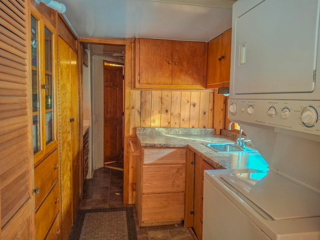 6741 Carpenter Rd, Harrison, MI 48625 - laundry area with stacked washer / drying machine and wooden walls