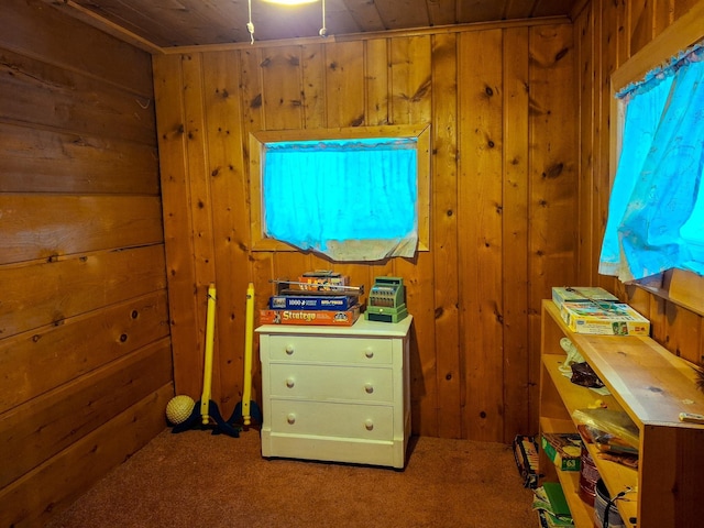 bedroom with carpet flooring, wood ceiling, and wooden walls