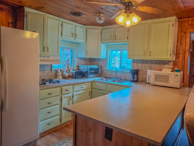 6741 Carpenter Rd, Harrison, MI 48625 - kitchen with white appliances, a sink, wood ceiling, a peninsula, and decorative backsplash