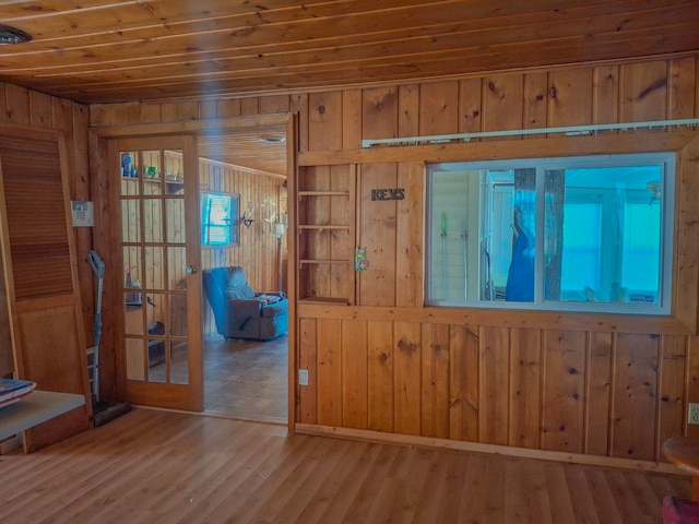 6741 Carpenter Rd, Harrison, MI 48625 - spare room with wooden walls, wooden ceiling, french doors, and wood finished floors