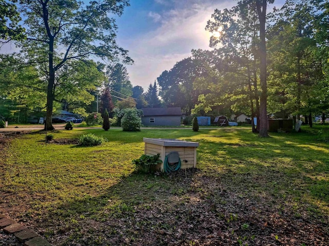 6741 Carpenter Rd, Harrison, MI 48625 - yard at dusk featuring a lawn