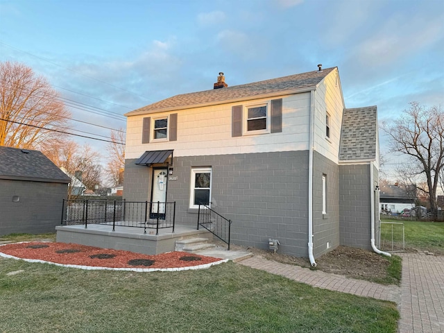 rear view of property featuring a yard