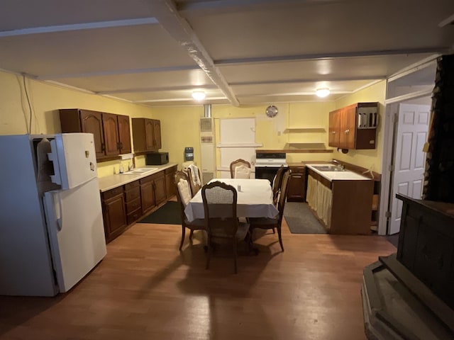 kitchen featuring hardwood / wood-style floors, white fridge, and sink