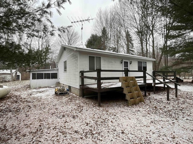 view of front of property with a sunroom and a wooden deck