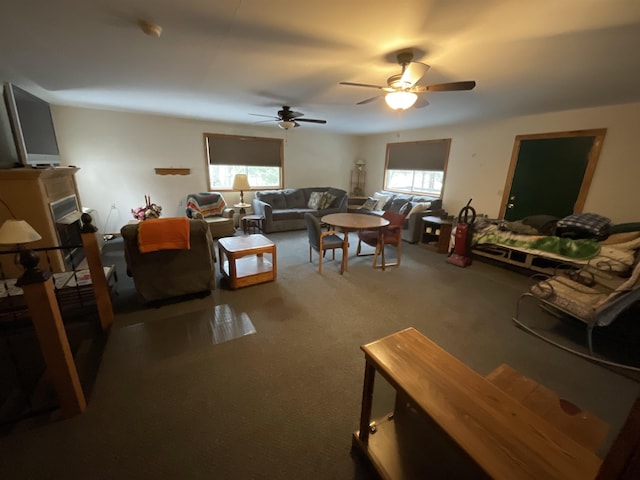 carpeted living room featuring ceiling fan and a healthy amount of sunlight