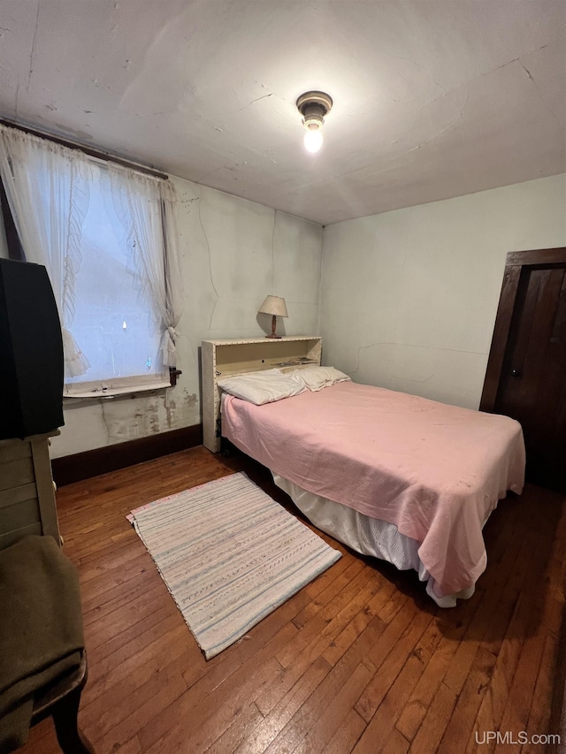 bedroom featuring dark hardwood / wood-style flooring