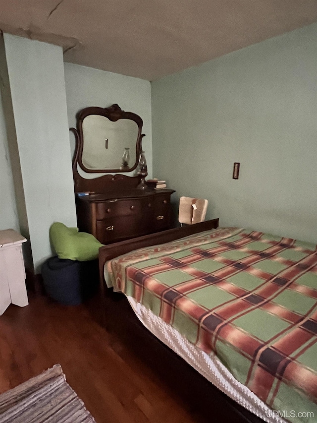 bedroom featuring dark hardwood / wood-style flooring