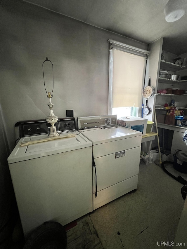 clothes washing area with washing machine and dryer