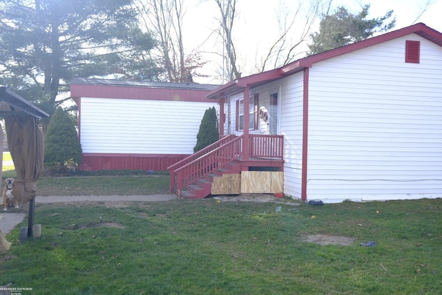 view of side of property with a lawn