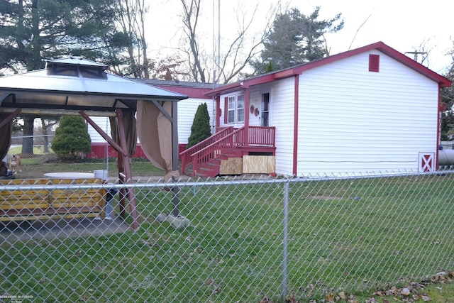 exterior space featuring a gazebo and a front lawn