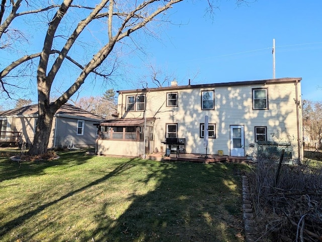 rear view of house featuring a lawn