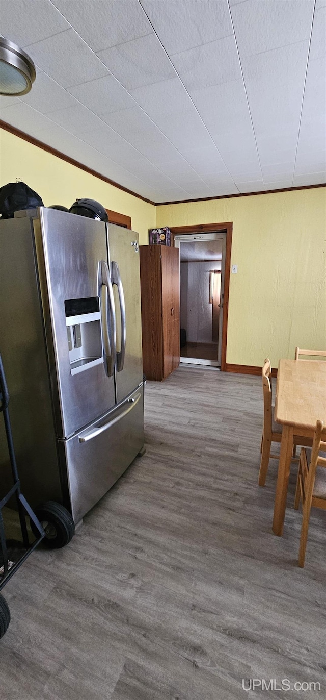 kitchen with hardwood / wood-style floors and stainless steel fridge