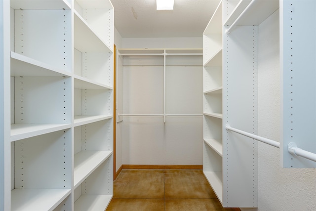 spacious closet with tile patterned flooring