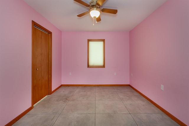 unfurnished room with ceiling fan and light tile patterned flooring