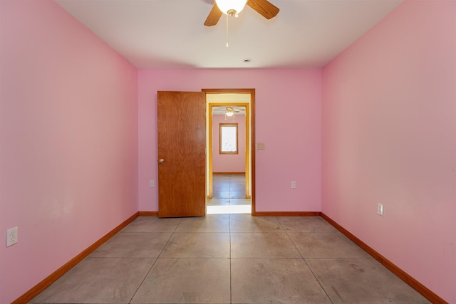 tiled empty room with ceiling fan