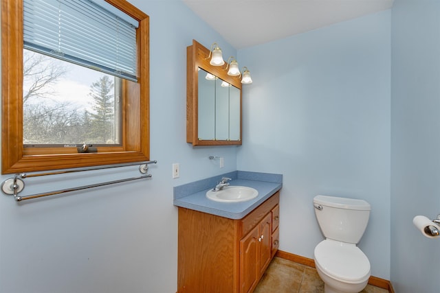 bathroom with tile patterned flooring, vanity, and toilet