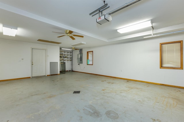 garage with electric panel, a garage door opener, and ceiling fan