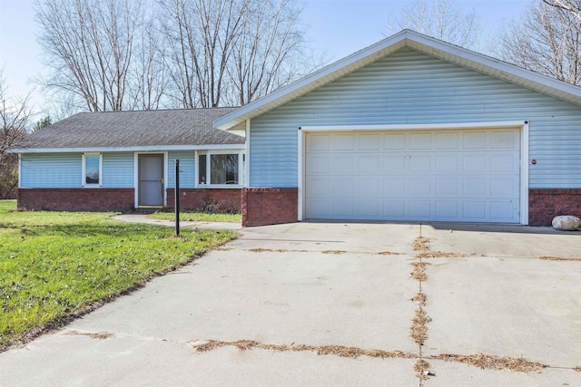 ranch-style house featuring a front yard and a garage