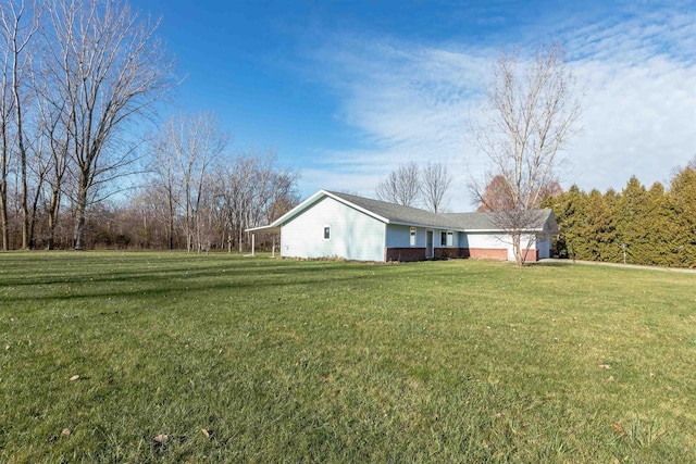 view of side of home with a lawn