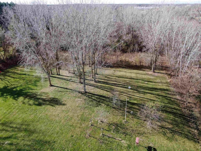 view of property's community featuring a rural view and a lawn