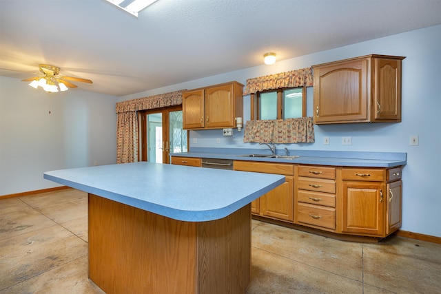 kitchen featuring a kitchen island, ceiling fan, stainless steel dishwasher, and sink