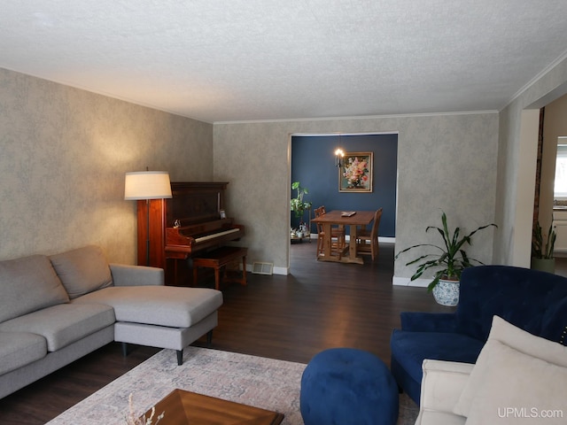 living room featuring crown molding, dark hardwood / wood-style flooring, and a textured ceiling