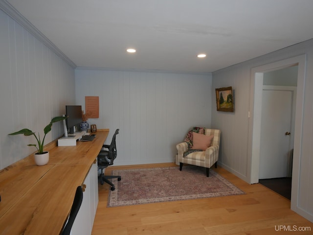 office space featuring wood walls, crown molding, and light hardwood / wood-style flooring