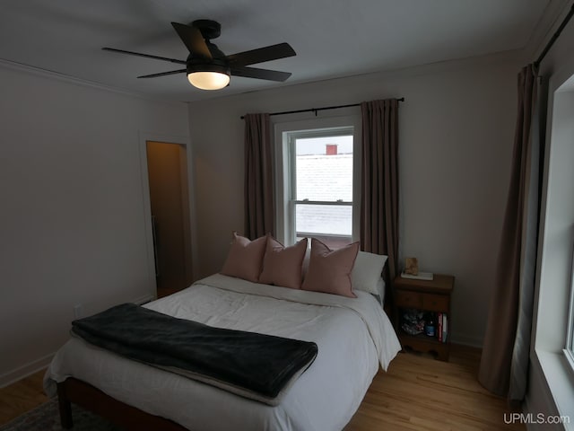 bedroom with ceiling fan and light hardwood / wood-style floors