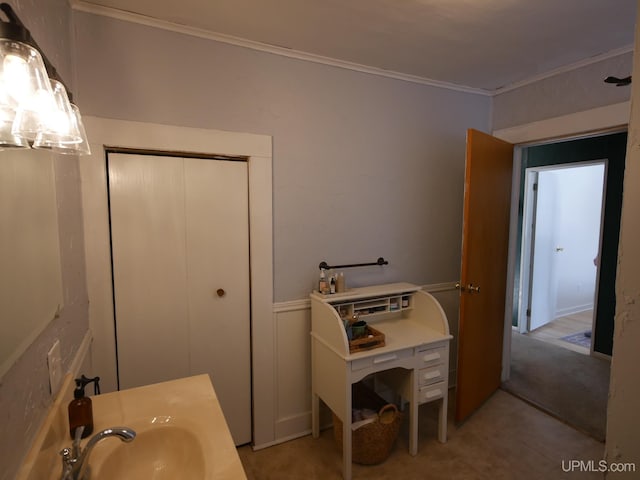 bathroom featuring ornamental molding and sink