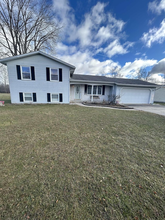 split level home featuring a front yard and a garage