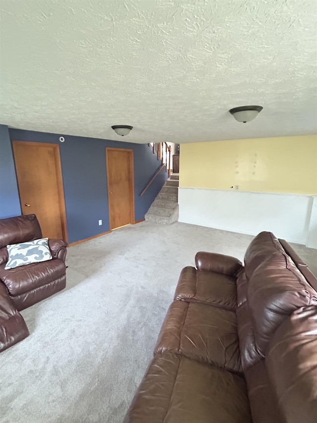 living room featuring carpet and a textured ceiling