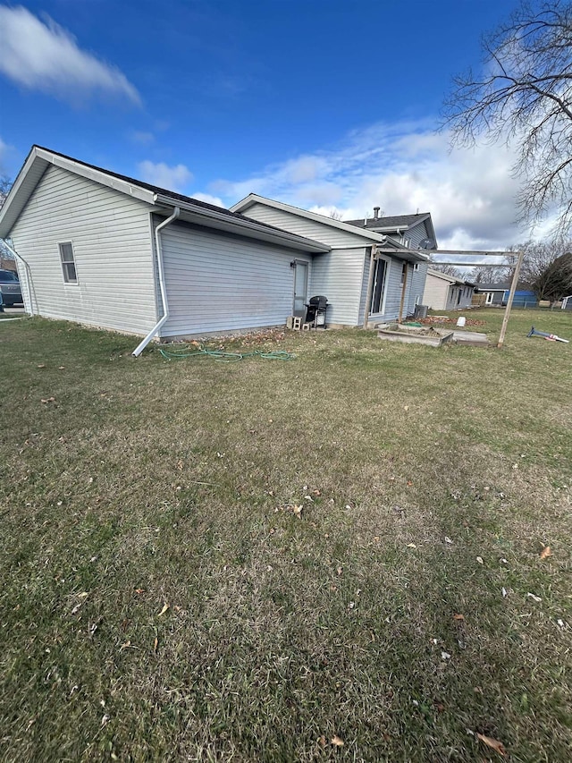 view of side of property with a lawn