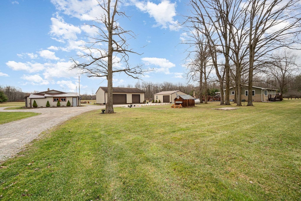 view of yard with a garage and an outdoor structure