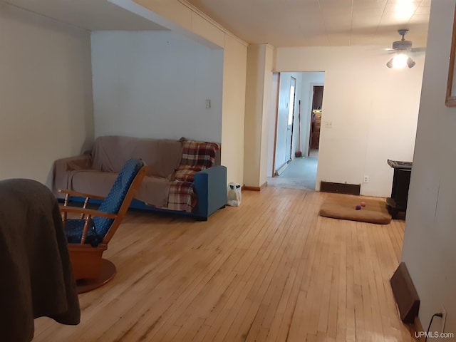 living room featuring ceiling fan and light hardwood / wood-style flooring