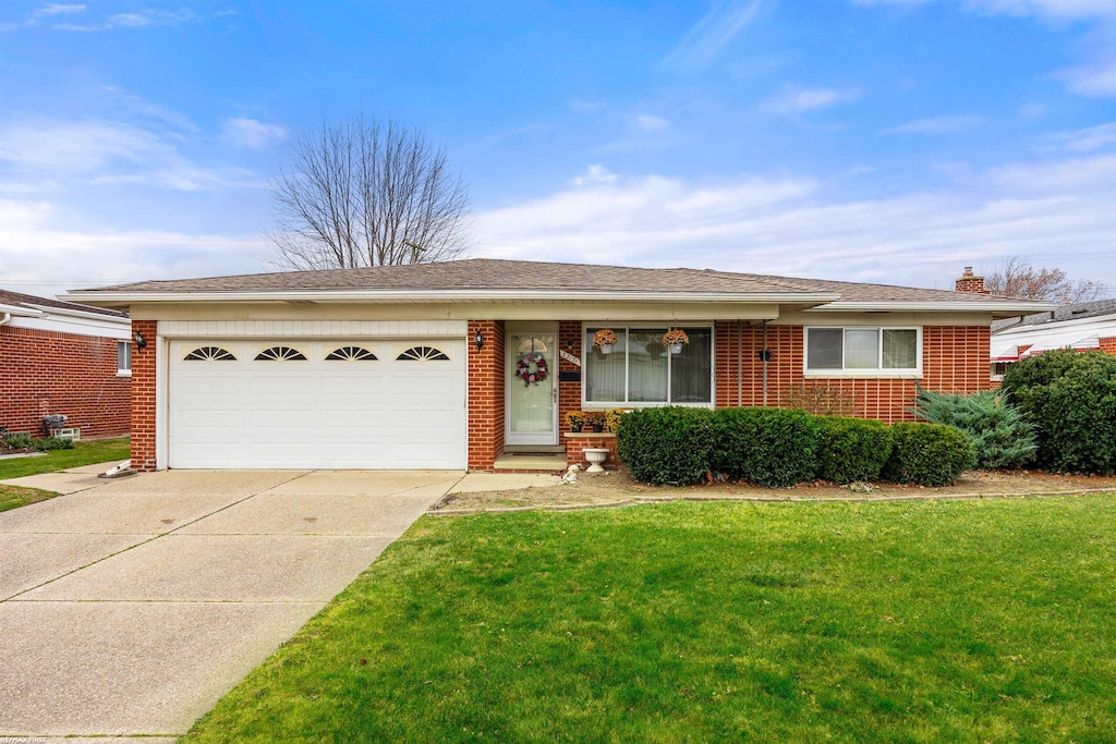 single story home featuring a front lawn and a garage