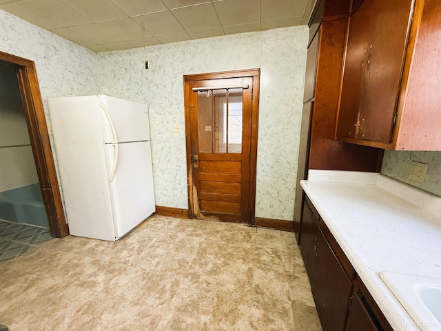 kitchen featuring white refrigerator and light colored carpet