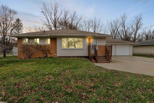 view of front of home with a yard and a garage