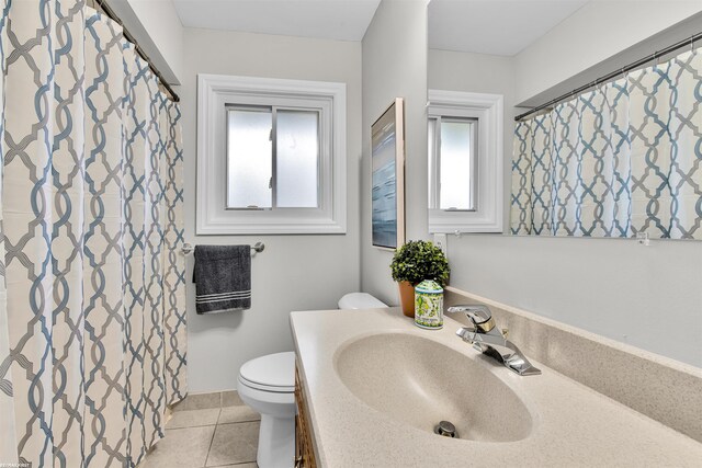 bathroom featuring tile patterned floors, vanity, and toilet