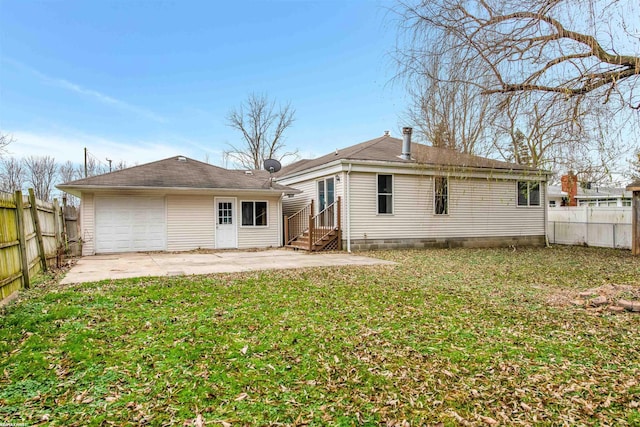 back of property with a patio area, a yard, and a garage