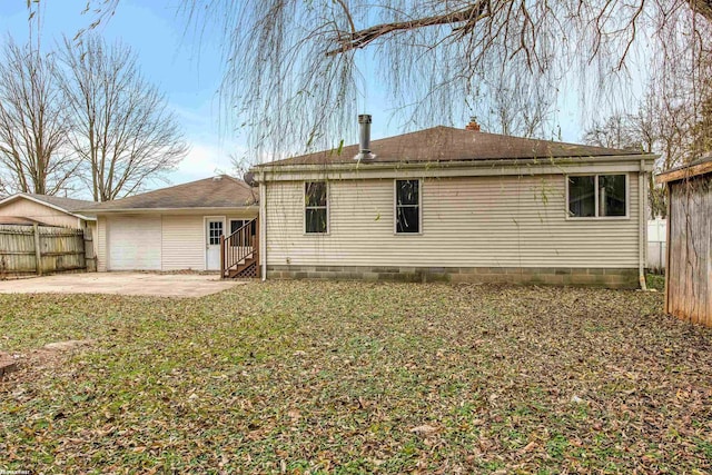 rear view of property featuring a lawn and a patio