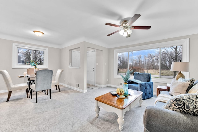 carpeted living room featuring ceiling fan