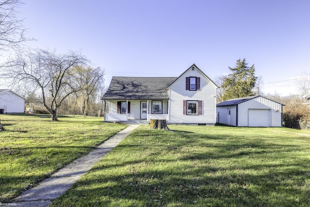 view of front of property featuring covered porch, an outbuilding, a garage, and a front lawn