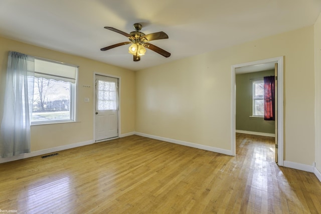 spare room with ceiling fan and light wood-type flooring