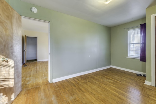 empty room with hardwood / wood-style floors